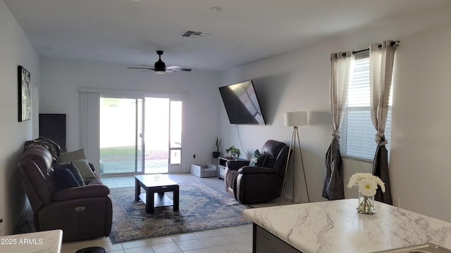 tiled living room featuring ceiling fan