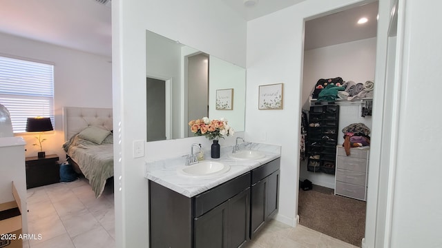 bathroom featuring tile patterned flooring and vanity