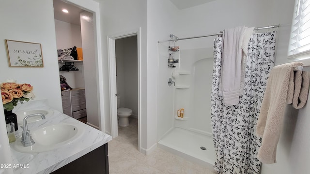 bathroom featuring tile patterned floors, vanity, curtained shower, and toilet