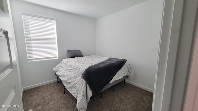 bedroom with dark colored carpet