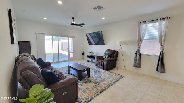 living room featuring ceiling fan and a healthy amount of sunlight