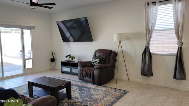 living room with ceiling fan and a healthy amount of sunlight