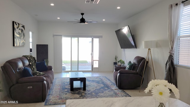 tiled living room with ceiling fan