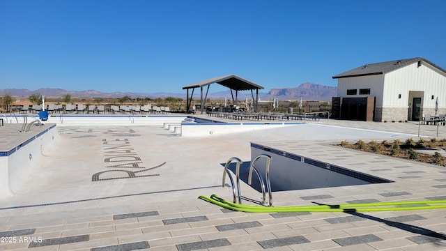 view of swimming pool with a mountain view