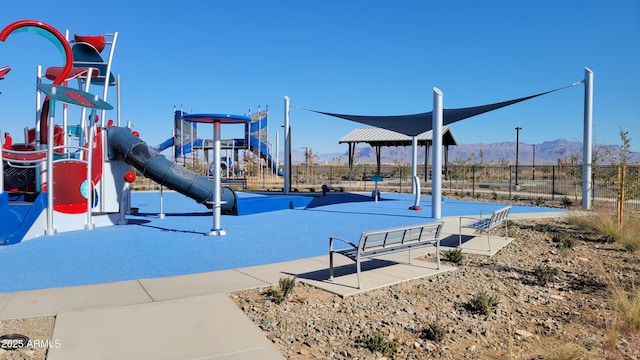 view of jungle gym featuring a mountain view