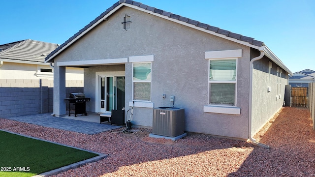 back of property featuring cooling unit and a patio area