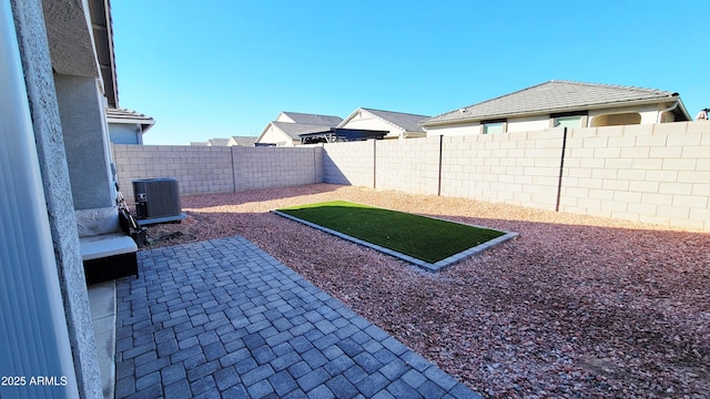 view of yard featuring a patio area and central air condition unit