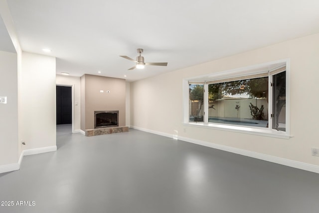 unfurnished living room with concrete flooring and ceiling fan