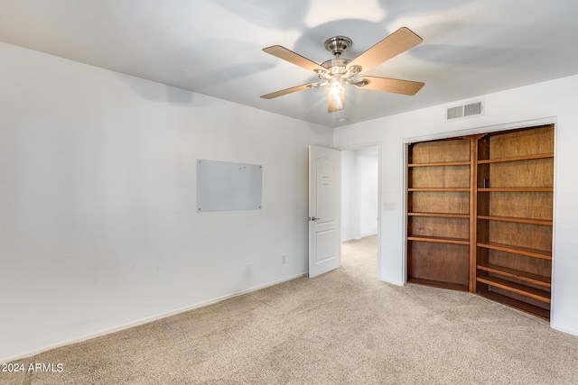 unfurnished room featuring light colored carpet and ceiling fan