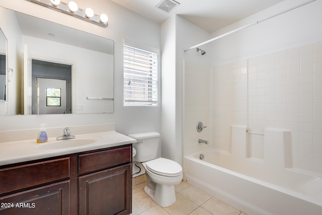 full bathroom featuring vanity, toilet, tile patterned flooring, and tiled shower / bath