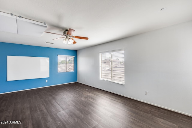 spare room featuring ceiling fan and dark hardwood / wood-style floors