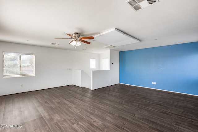 unfurnished room with dark hardwood / wood-style floors, ceiling fan, and a wealth of natural light