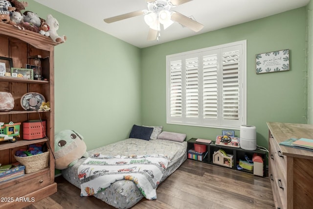 bedroom with a ceiling fan and wood finished floors