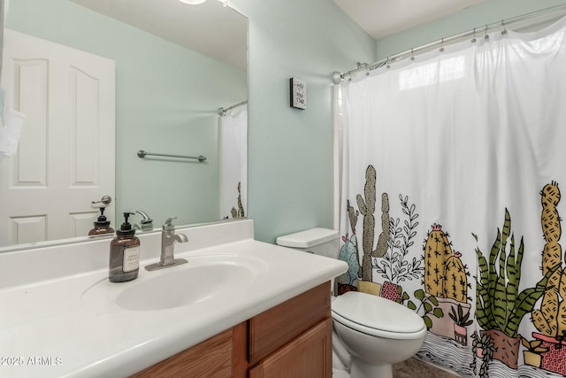 bathroom with vanity, toilet, and curtained shower