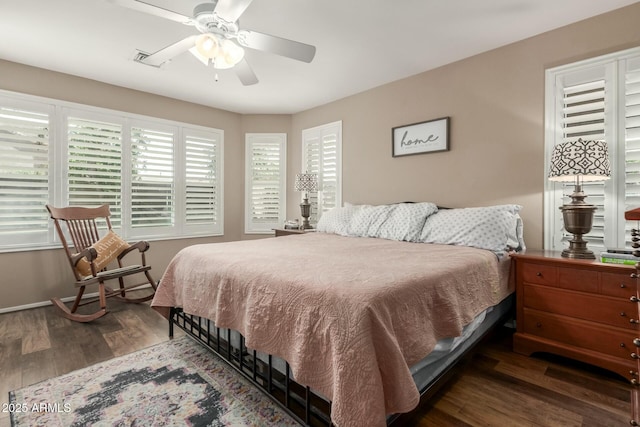 bedroom with baseboards, ceiling fan, and wood finished floors