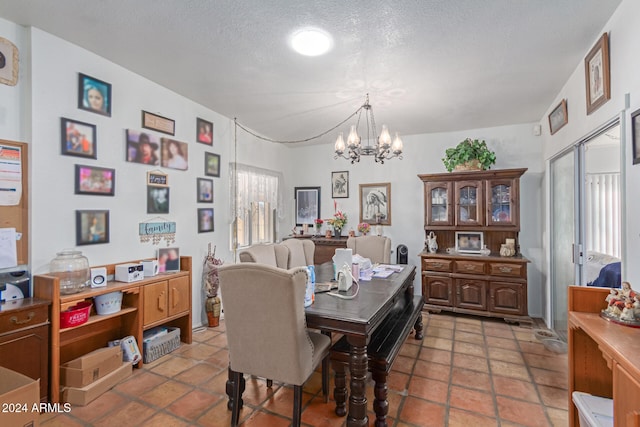 dining room featuring a chandelier and a textured ceiling