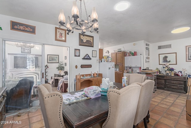 dining room featuring a textured ceiling and a notable chandelier