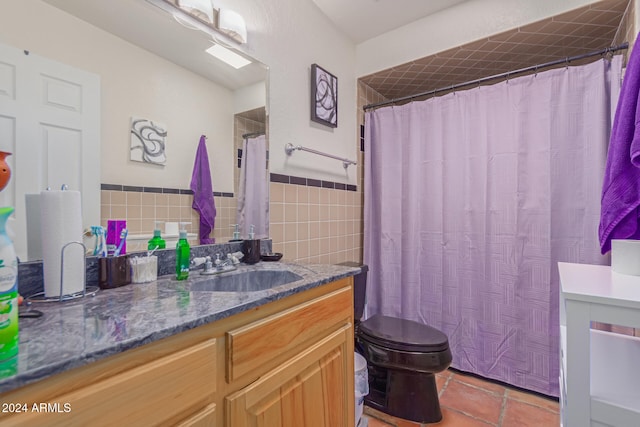 bathroom with walk in shower, tile patterned floors, toilet, vanity, and tile walls