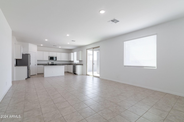 4702 S 109th Ave, Tolleson, AZ 85353 - unfurnished living room with light tile patterned floors, baseboards, visible vents, and recessed lighting