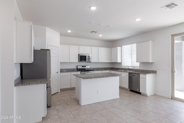 4702 S 109th Ave, Tolleson, AZ 85353 - kitchen with white cabinets, stainless steel appliances, a center island, and visible vents