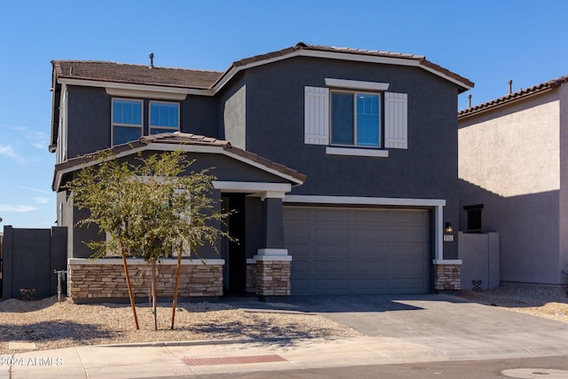 4702 S 109th Ave, Tolleson, AZ 85353 - view of front facade featuring a tile roof, driveway, stone siding, a garage, and stucco siding