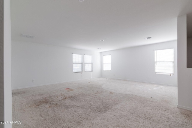 4702 S 109th Ave, Tolleson, AZ 85353 - spare room featuring baseboards, visible vents, and carpet