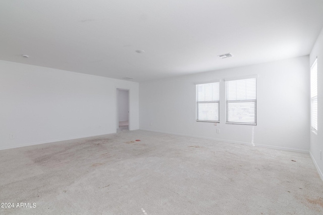 4702 S 109th Ave, Tolleson, AZ 85353 - spare room featuring baseboards, visible vents, and light colored carpet