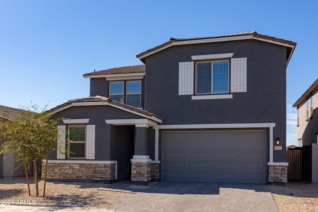 4702 S 109th Ave, Tolleson, AZ 85353 - traditional-style house featuring stucco siding, an attached garage, a tile roof, decorative driveway, and stone siding