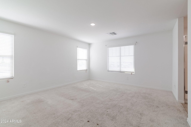 4702 S 109th Ave, Tolleson, AZ 85353 - spare room featuring baseboards, visible vents, and light colored carpet