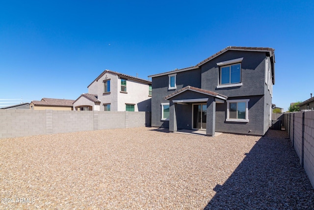 4702 S 109th Ave, Tolleson, AZ 85353 - back of property with stucco siding, a tile roof, a patio area, and a fenced backyard