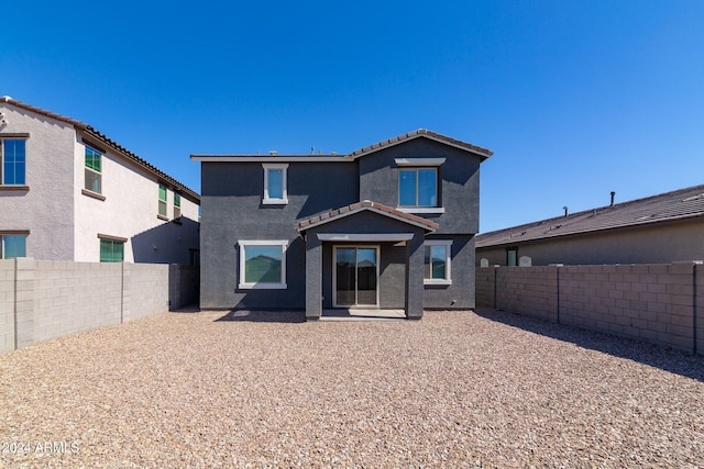 4702 S 109th Ave, Tolleson, AZ 85353 - rear view of property with a tile roof, a fenced backyard, and stucco siding