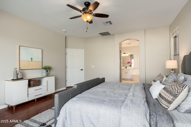 bedroom with dark hardwood / wood-style floors, ceiling fan, and ensuite bathroom