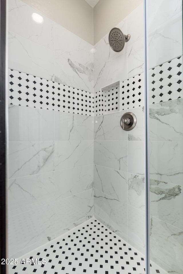 bathroom with tiled shower