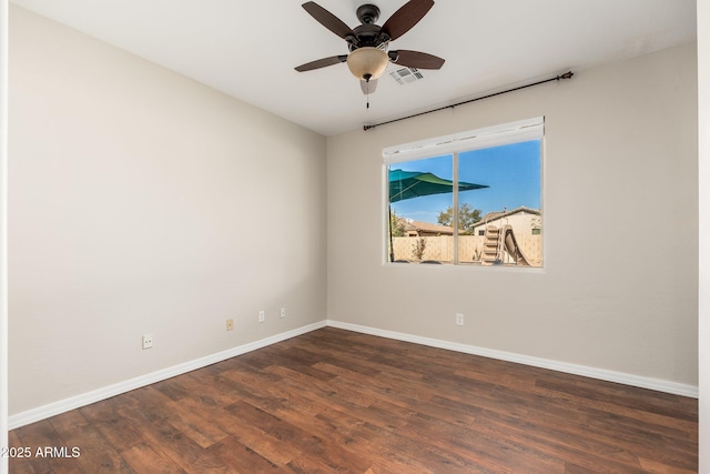 spare room with dark wood-type flooring and ceiling fan