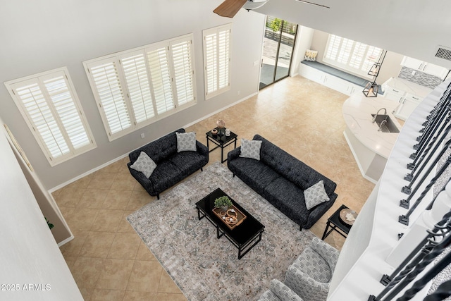 tiled living room with ceiling fan