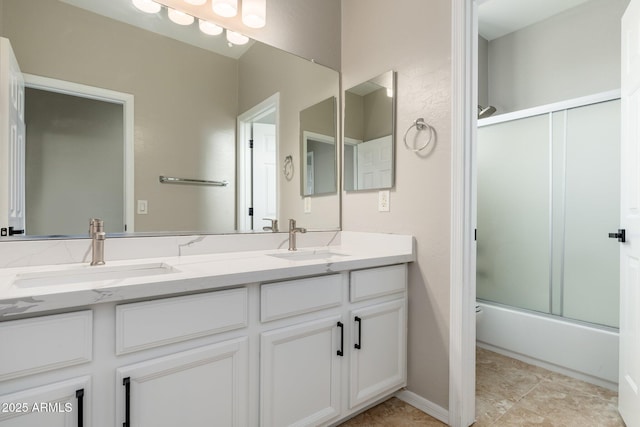 bathroom featuring vanity and bath / shower combo with glass door