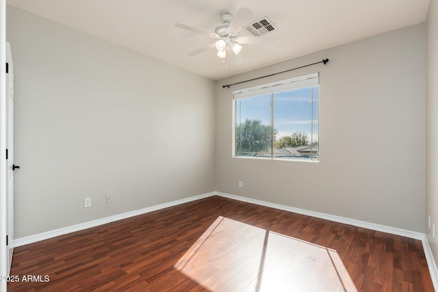 unfurnished room with dark hardwood / wood-style flooring and ceiling fan