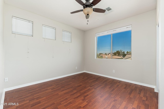 empty room featuring dark hardwood / wood-style floors and ceiling fan