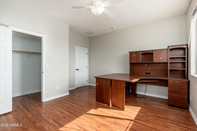 unfurnished office featuring dark hardwood / wood-style floors and ceiling fan