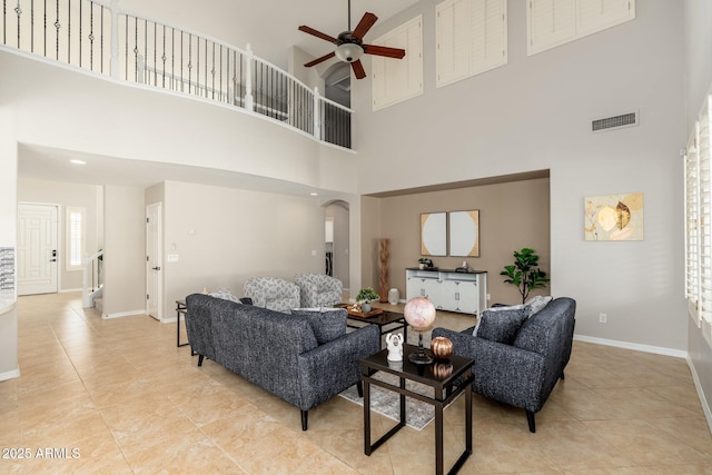 living room featuring light tile patterned floors and ceiling fan