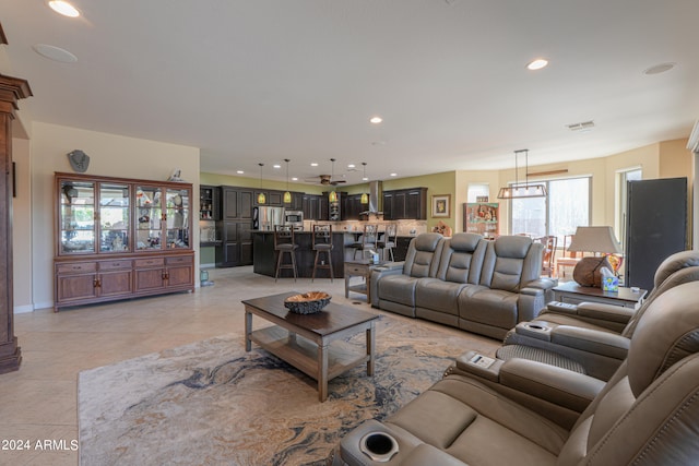 living room featuring light tile patterned flooring and an inviting chandelier