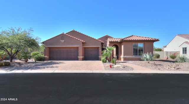 mediterranean / spanish-style house featuring a garage