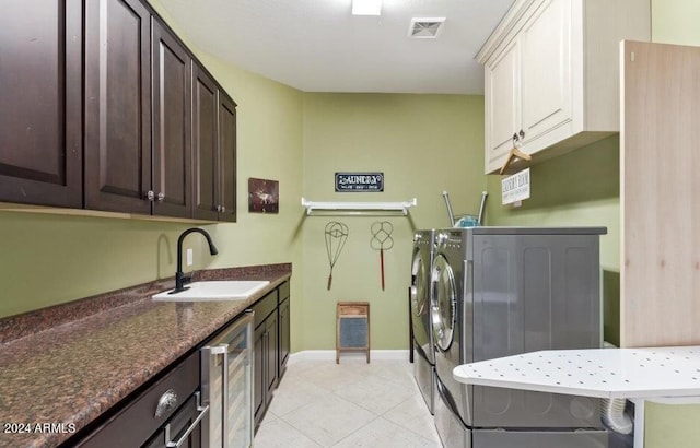 laundry area with beverage cooler, sink, light tile patterned flooring, cabinets, and washer and dryer