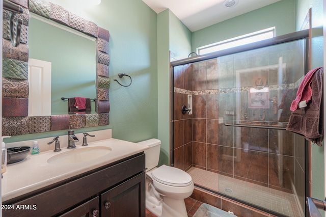 bathroom with vanity, tile patterned flooring, toilet, and an enclosed shower