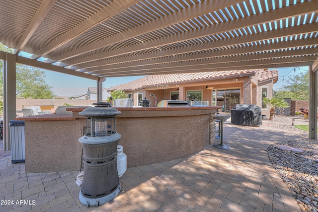 view of patio / terrace with a pergola, area for grilling, and an outdoor bar