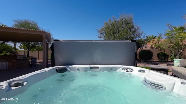 view of pool with a hot tub