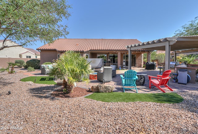 back of house with a patio, a fire pit, and a pergola