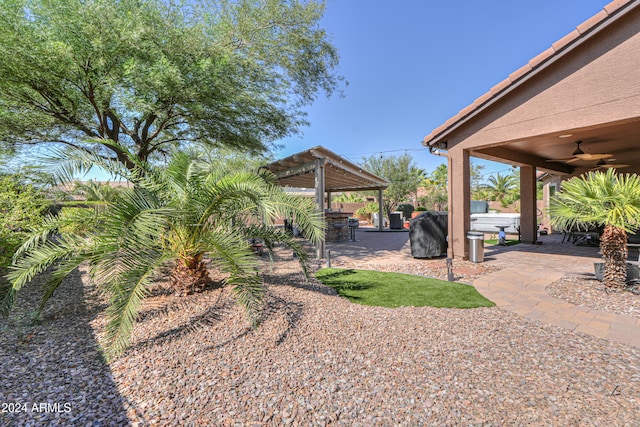 view of yard featuring a patio, ceiling fan, and a pergola