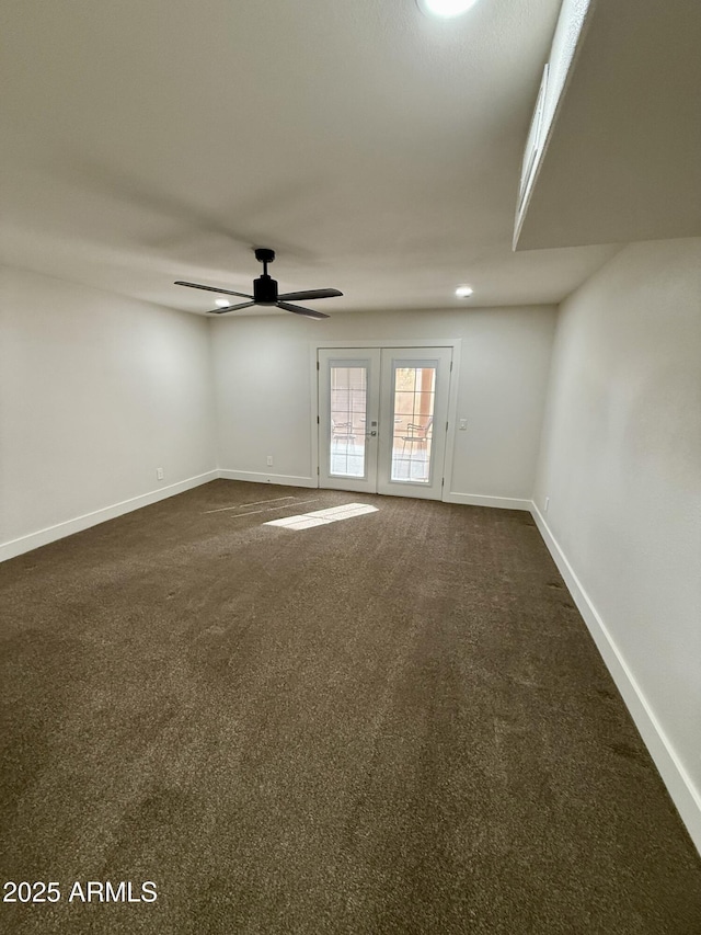 unfurnished room with ceiling fan, dark carpet, and french doors