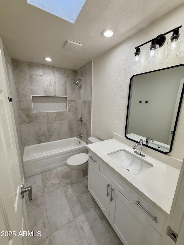 full bathroom with toilet, tiled shower / bath combo, and vanity